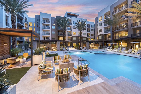 Inviting pool area with lounge chairs at Sunela Apartments, a Greystar luxury property