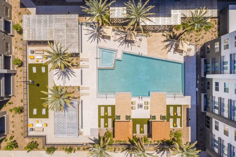 Resort-style pool with lounging areas at Sunela Apartments, a Greystar luxury community