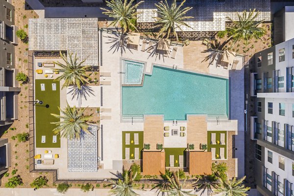Resort-style pool with lounging areas at Sunela Apartments, a Greystar luxury community