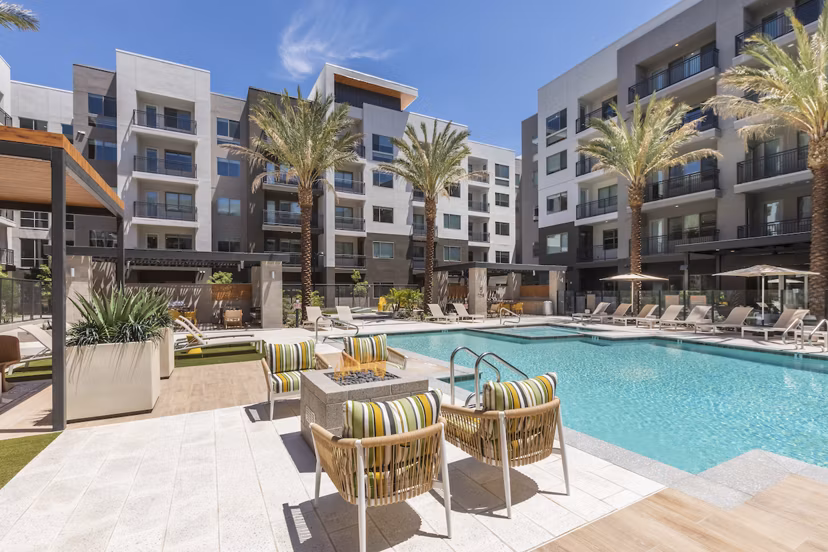 Resort-style pool with lounge chairs at Sunela Apartments, perfect for relaxation and leisure at a Greystar luxury property