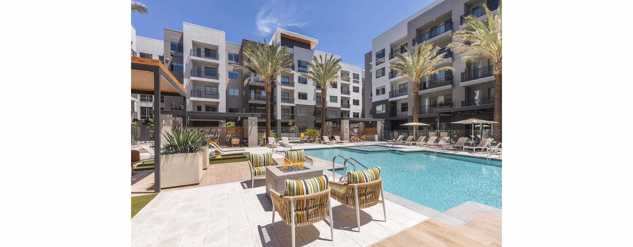 Resort-style pool with lounge chairs at Sunela Apartments, perfect for relaxation and leisure at a Greystar luxury property