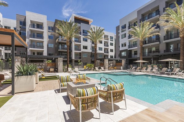 Resort-style pool with lounge chairs at Sunela Apartments, perfect for relaxation and leisure at a Greystar luxury property