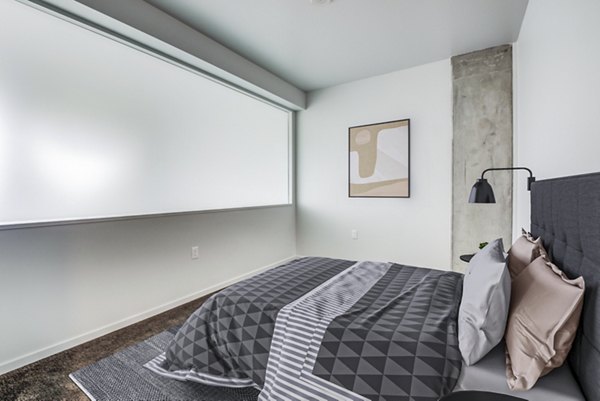 Modern bedroom with sleek decor and natural light at Vance Apartments in luxury Greystar location