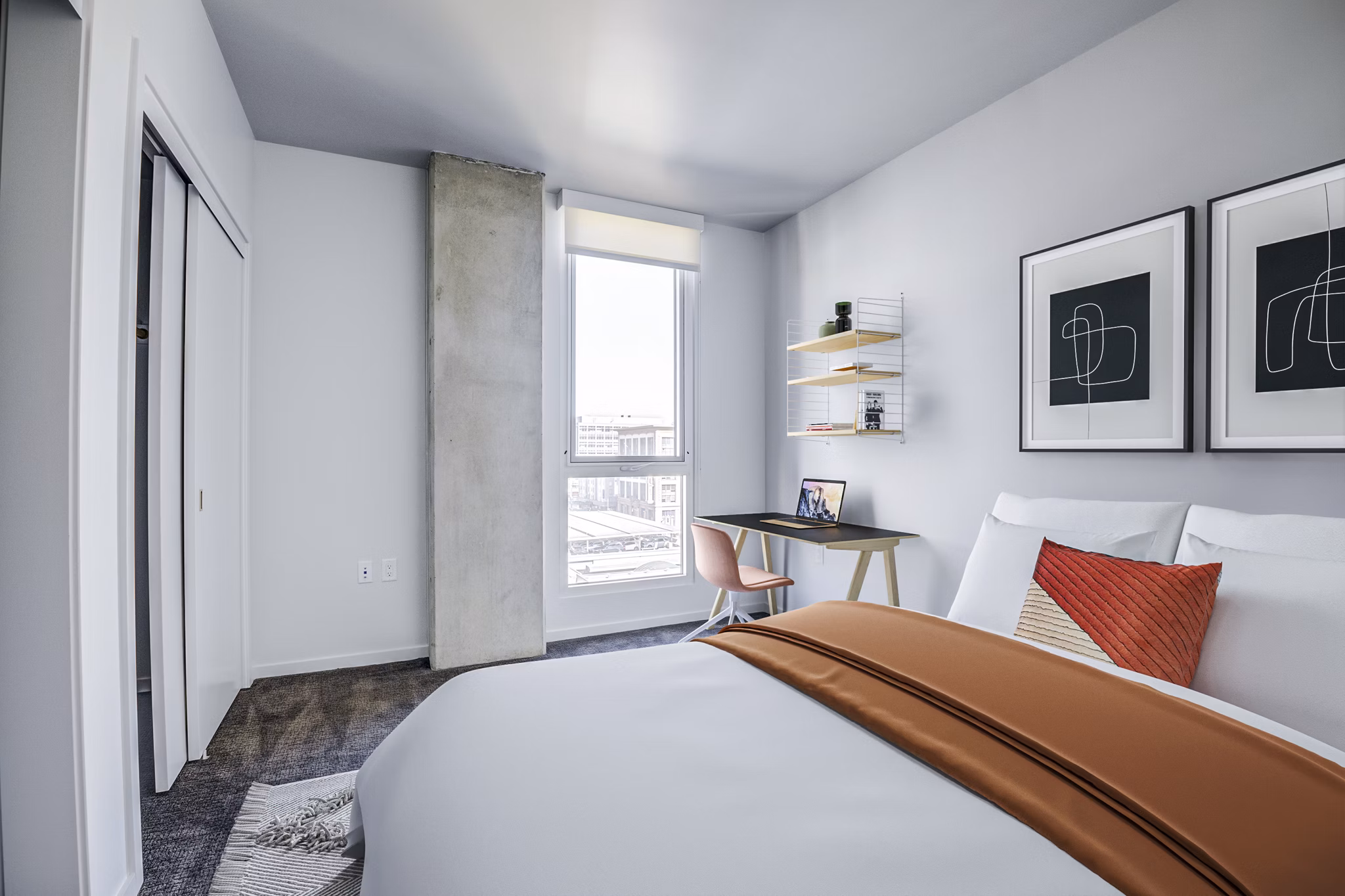 Modern bedroom with elegant decor featuring plush bedding at Vance Apartments
