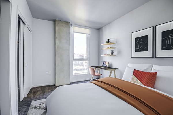 Modern bedroom with elegant decor featuring plush bedding at Vance Apartments