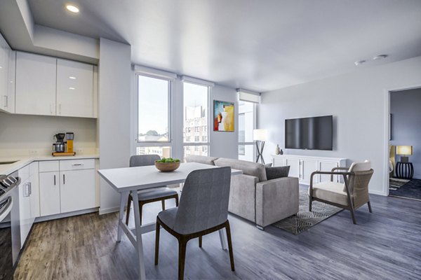 Dining room with modern decor and large windows at Vance Apartments, a Greystar luxury property in an urban setting