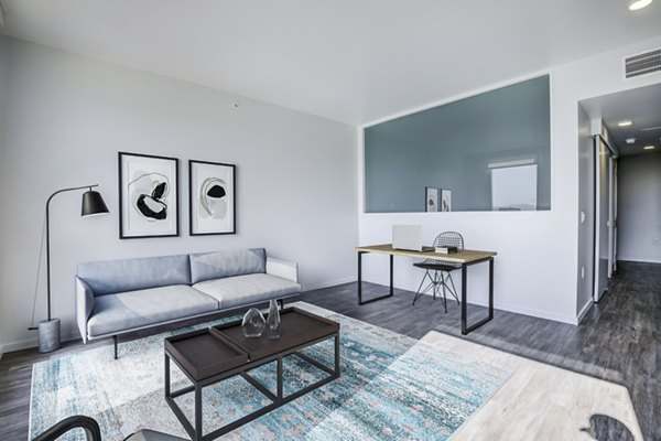 Spacious living room with modern decor and ample natural light at Vance Apartments
