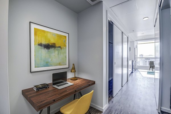 Home office space with ergonomic chair and desk setup at Vance Apartments