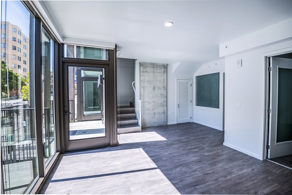 Spacious living room with modern decor and city views at Vance Apartments