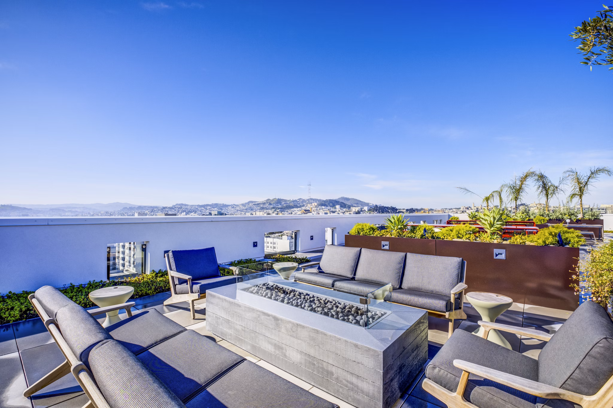 Cozy fire pit seating area on patio at Vance Apartments, offering luxury outdoor relaxation