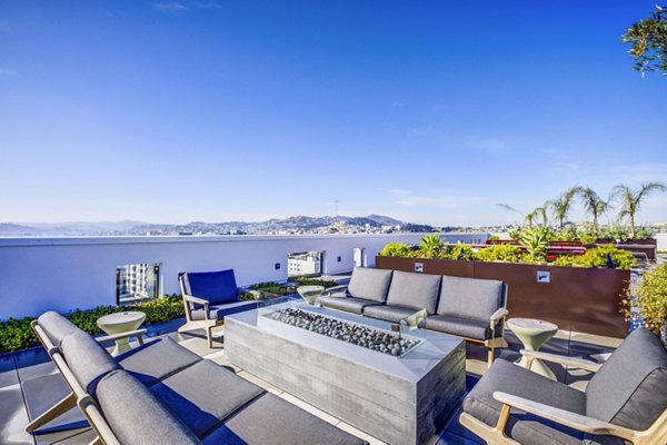Cozy fire pit seating area on patio at Vance Apartments, offering luxury outdoor relaxation