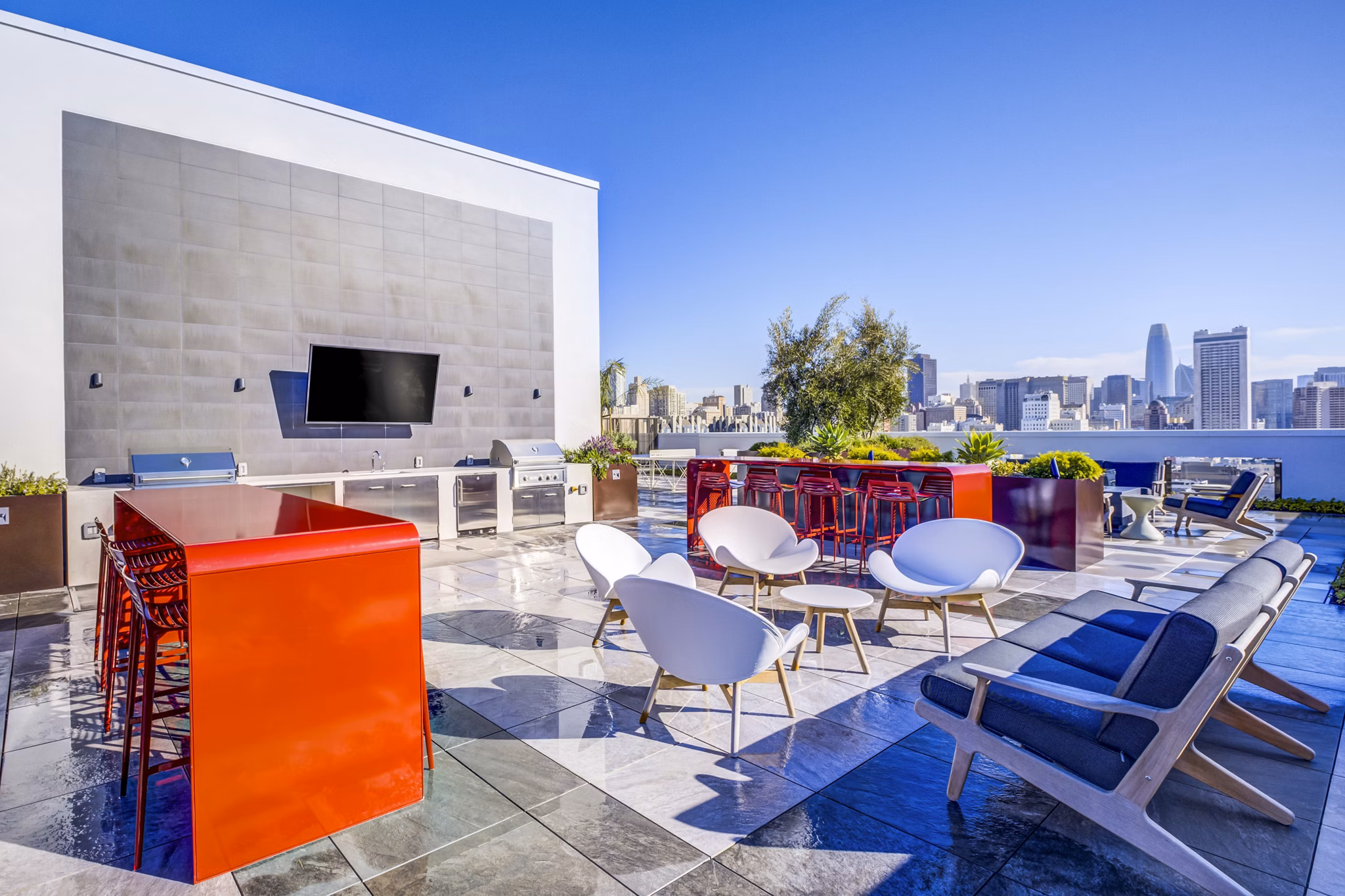 Outdoor grill area at Vance Apartments featuring modern patio furniture and lush landscaping