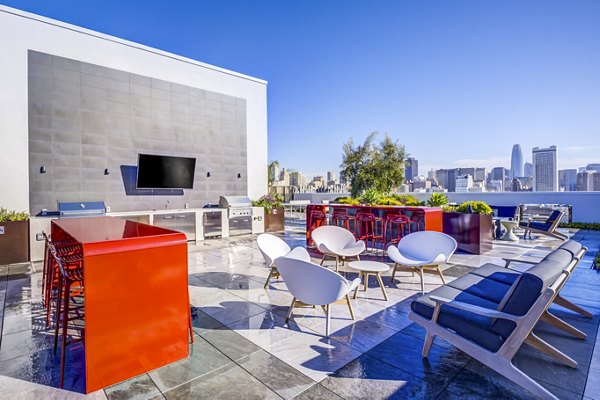 Outdoor grill area at Vance Apartments featuring modern patio furniture and lush landscaping