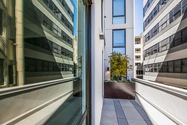 Private patio with outdoor seating at Vance Apartments, offering tranquil views in a luxury setting