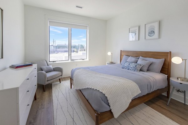 Contemporary bedroom with chic decor at Harrison Yards Apartments
