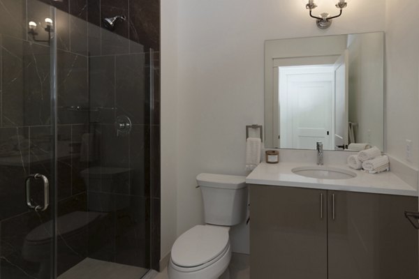 Sleek bathroom with modern fixtures at Harrison Yards Apartments, luxury living experience in a prime urban location