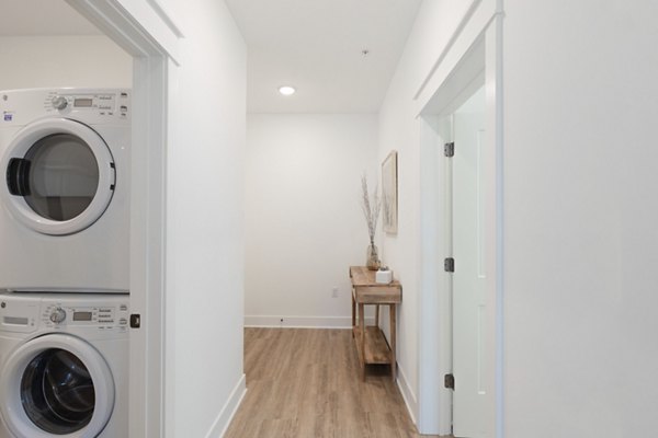 Modern hallway featuring artistic lighting and sleek design at Harrison Yards Apartments