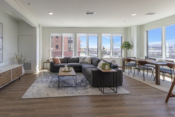Contemporary living room with sleek furnishings at Harrison Yards Apartments