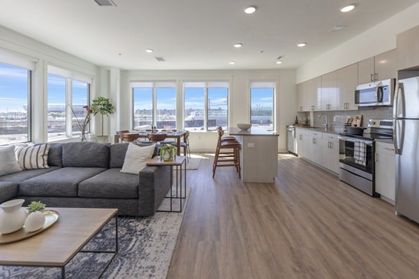 Spacious living room with contemporary furnishings at Harrison Yards Apartments