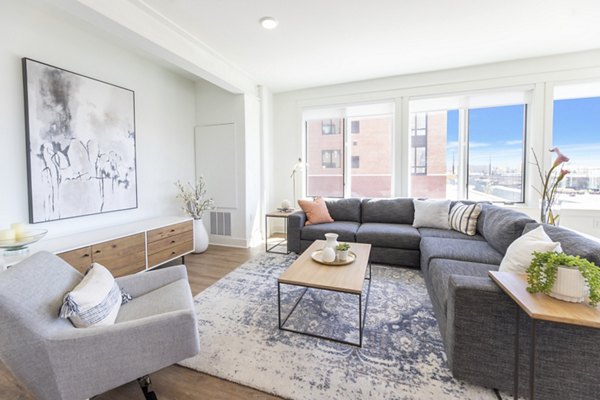 Spacious living room with modern furnishings at Harrison Yards Apartments