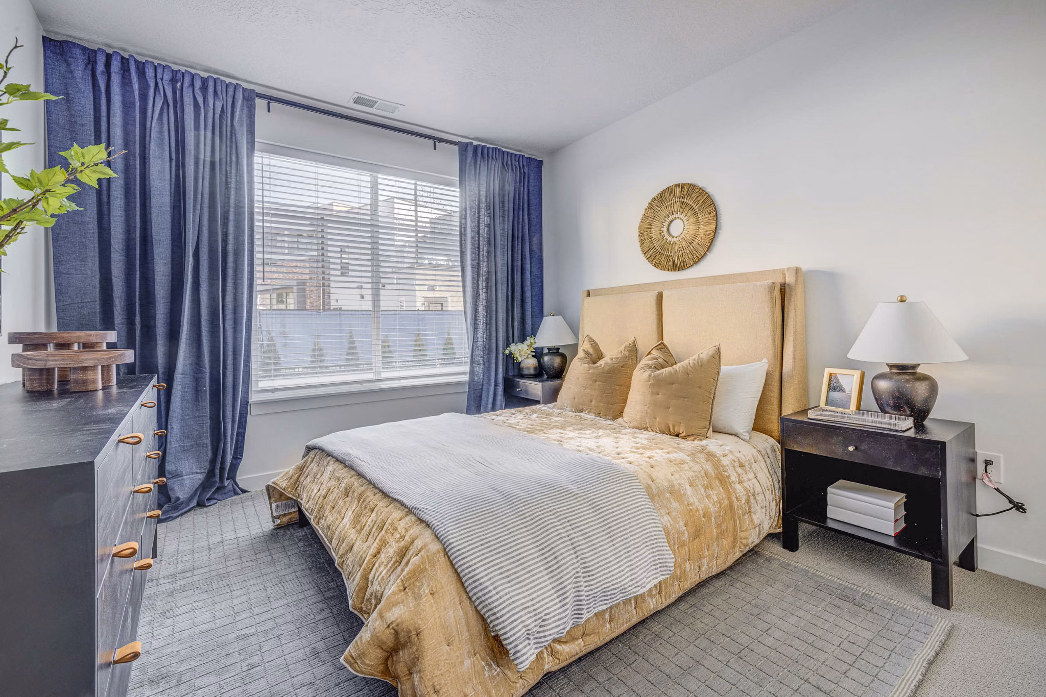 Bedroom featuring sleek modern furnishings at Reveal Apartments