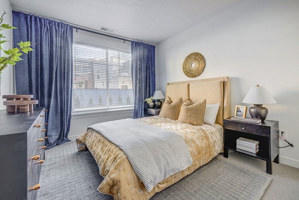 Bedroom featuring sleek modern furnishings at Reveal Apartments