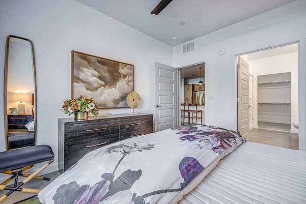 Modern bedroom with elegant decor at Reveal Apartments in a vibrant community