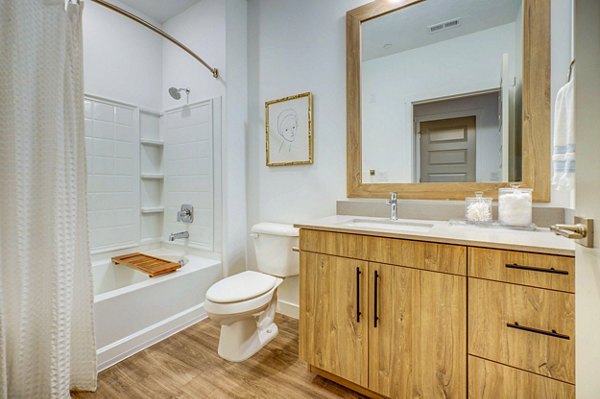 Modern bathroom featuring sleek fixtures at Reveal Apartments