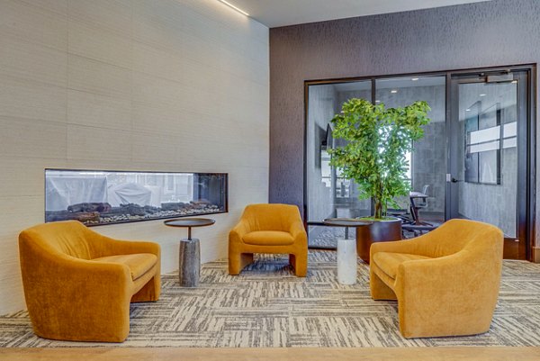 Luxurious clubhouse featuring modern decor and ample seating at Reveal Apartments