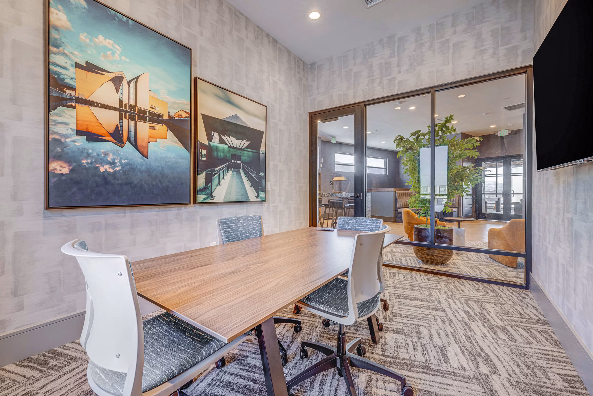 Clubhouse meeting facility with modern furnishings at Reveal Apartments, perfect for gatherings and business events