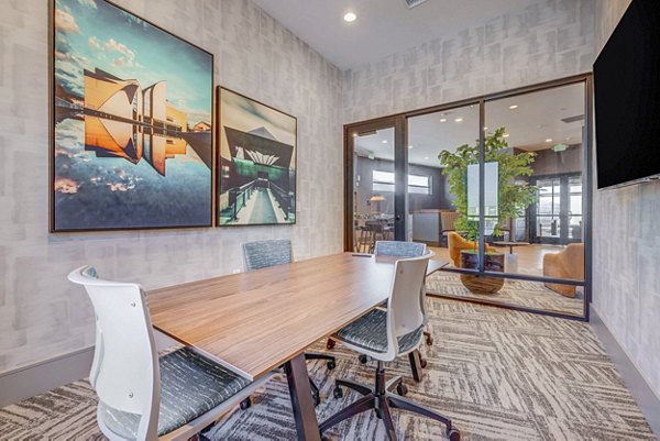 Clubhouse meeting facility with modern furnishings at Reveal Apartments, perfect for gatherings and business events