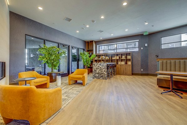 Clubhouse featuring modern design and entertainment space at Reveal Apartments, a luxury Greystar community in a prime location