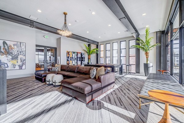 Clubhouse featuring modern design and spacious seating at Reveal Apartments