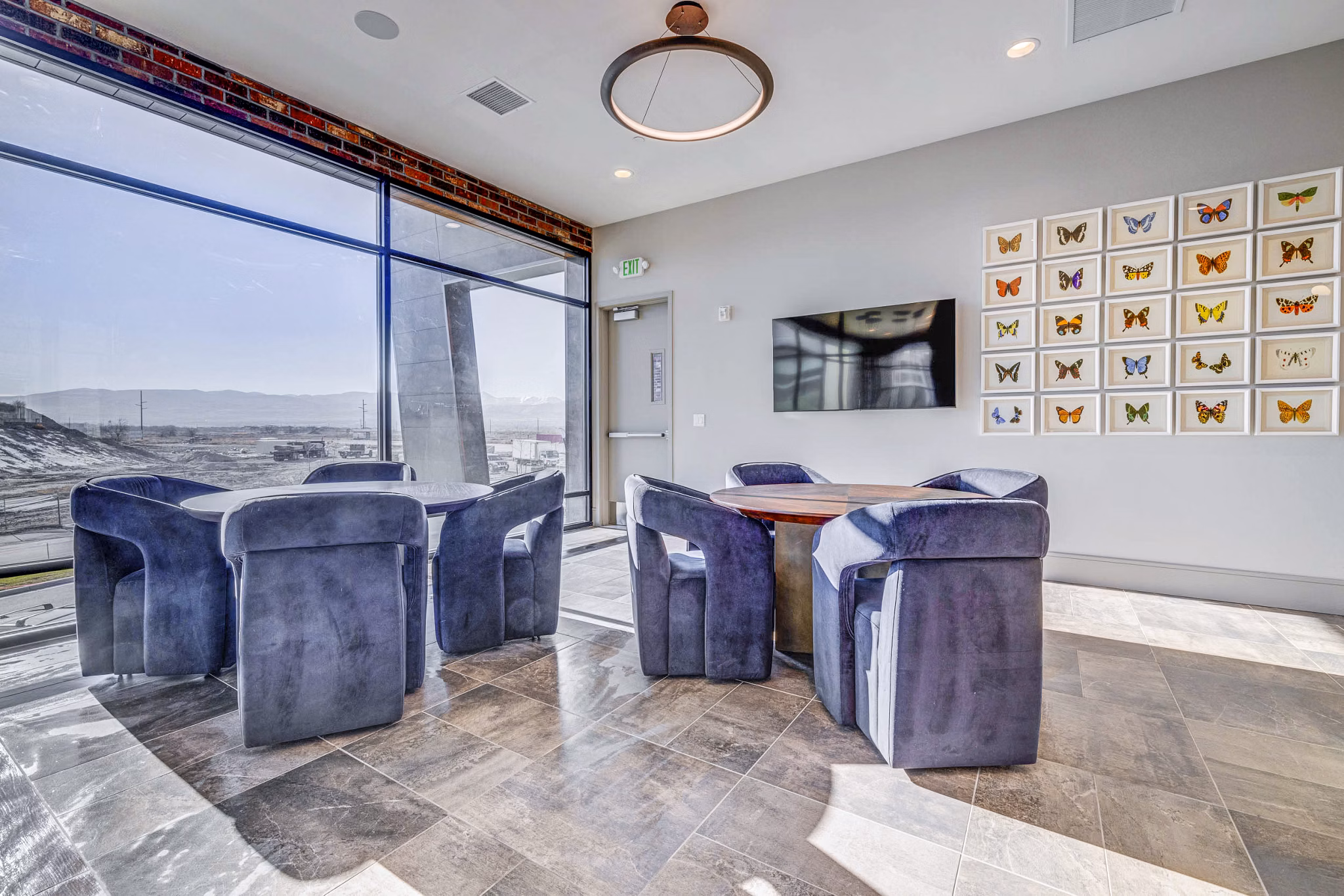 Chic clubhouse with modern decor at Reveal Apartments, perfect for social gatherings and relaxation