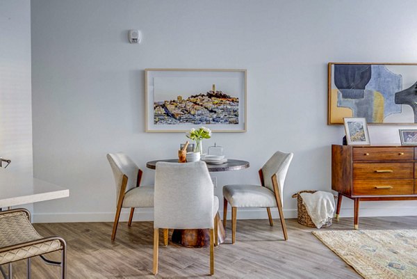 Dining room featuring modern decor and elegant lighting at Reveal Apartments