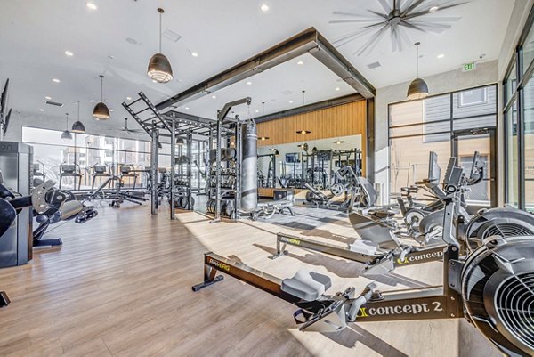 State-of-the-art fitness center at Reveal Apartments with modern equipment for exercise and wellness