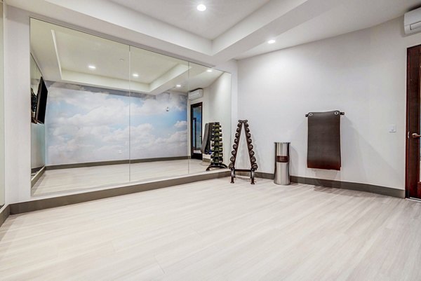 Peaceful yoga studio with natural lighting at Reveal Apartments fitness center