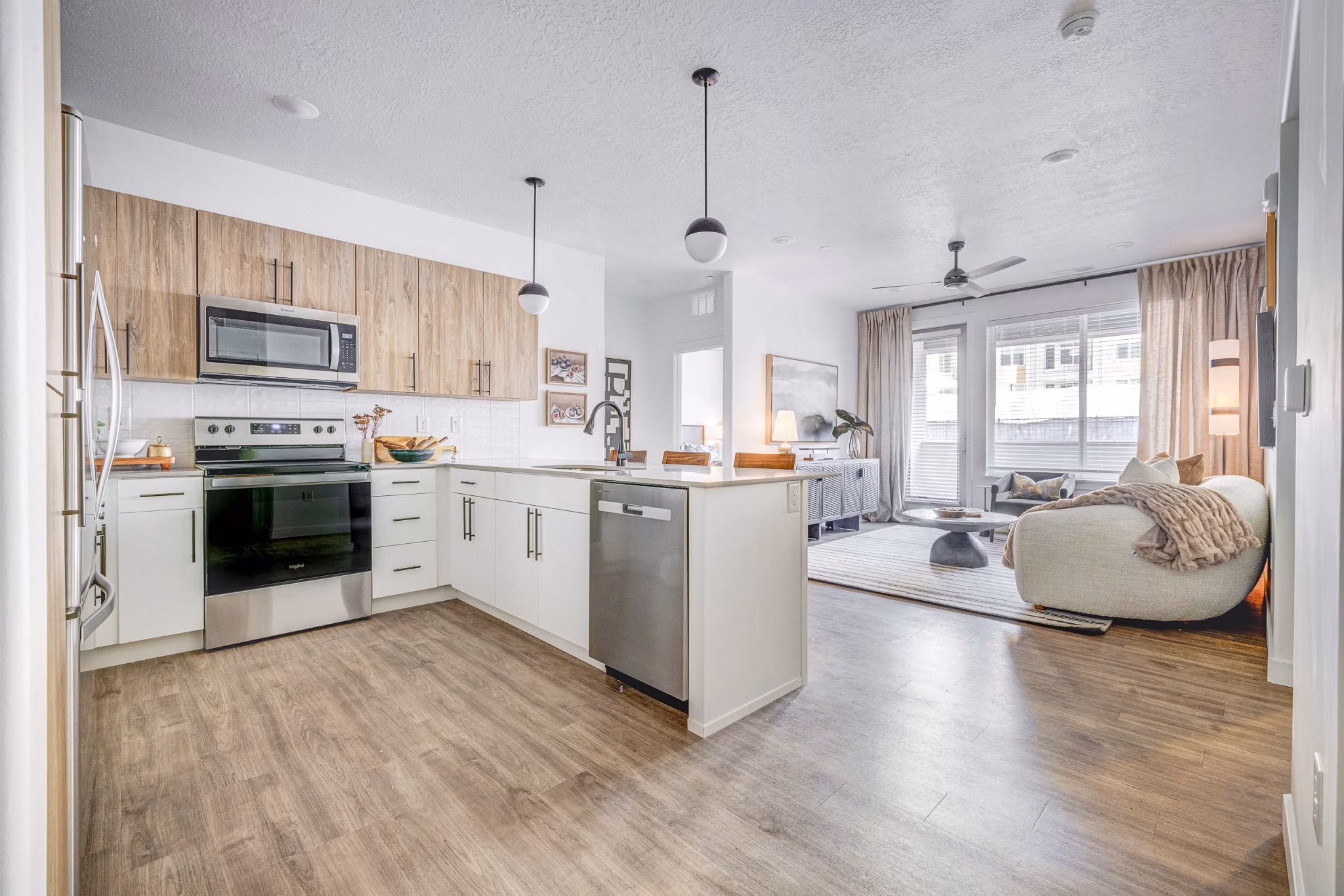 Modern kitchen featuring stainless steel appliances and granite countertops at Reveal Apartments, Greystar luxury living in city center