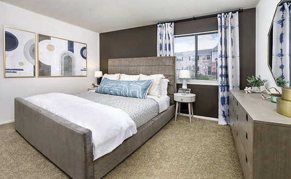 Bedroom featuring modern decor and large windows in Cobalt Ridge Apartments