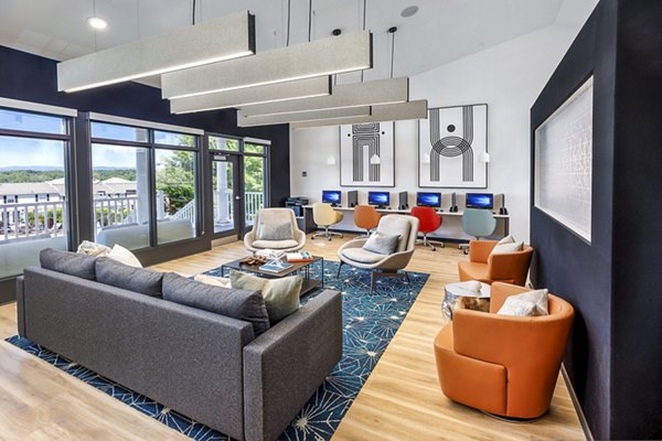 Modern business center at Cobalt Ridge Apartments featuring workstations and conference rooms for residents' convenience