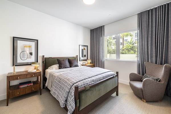 Bedroom with cozy decor and natural light at Hollywood Park Apartments