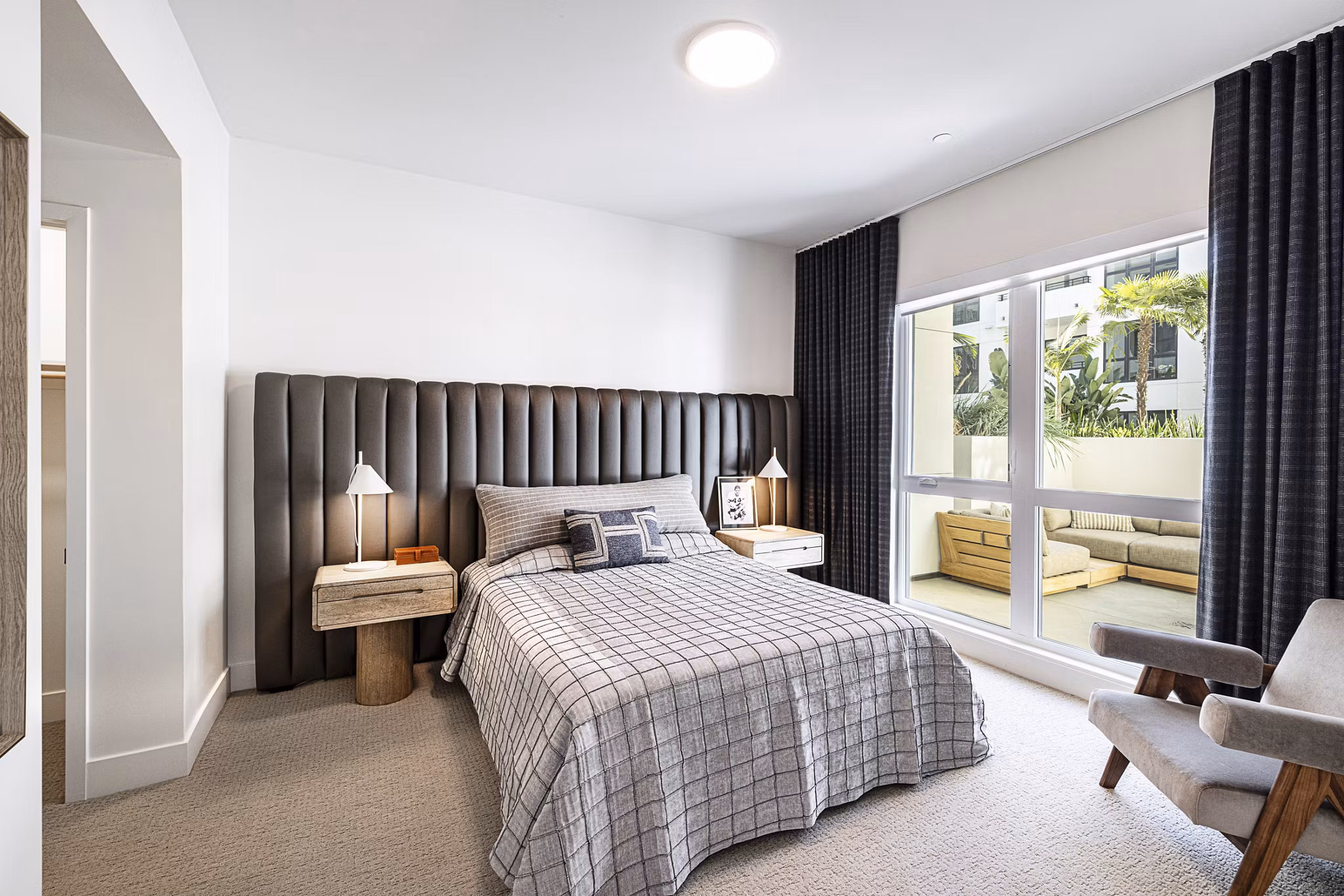 Hollywood Park Apartments: Modern bedroom featuring luxury bedding and city views