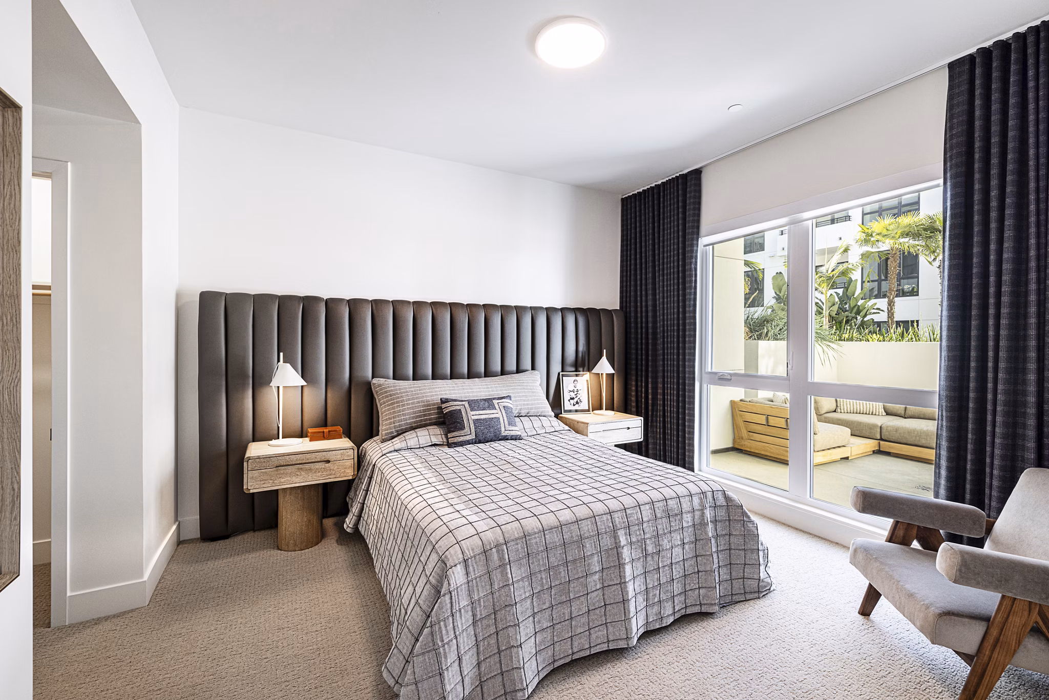 Hollywood Park Apartments: Modern bedroom featuring luxury bedding and city views