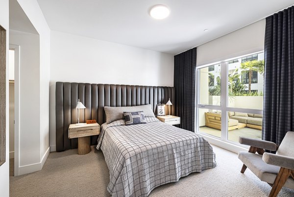Hollywood Park Apartments: Modern bedroom featuring luxury bedding and city views