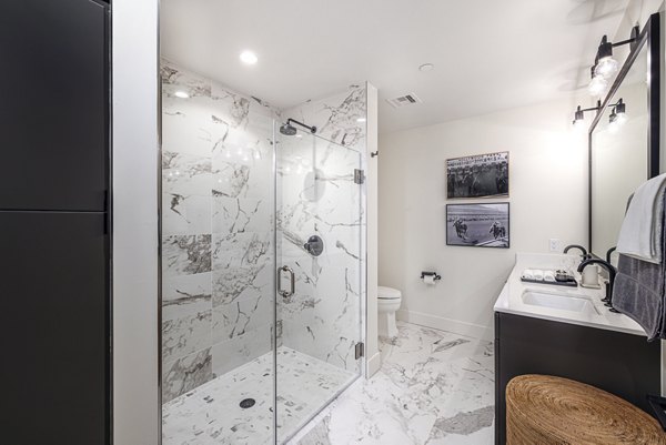 Modern bathroom with sleek fixtures at Hollywood Park Apartments: luxury living in a Greystar community