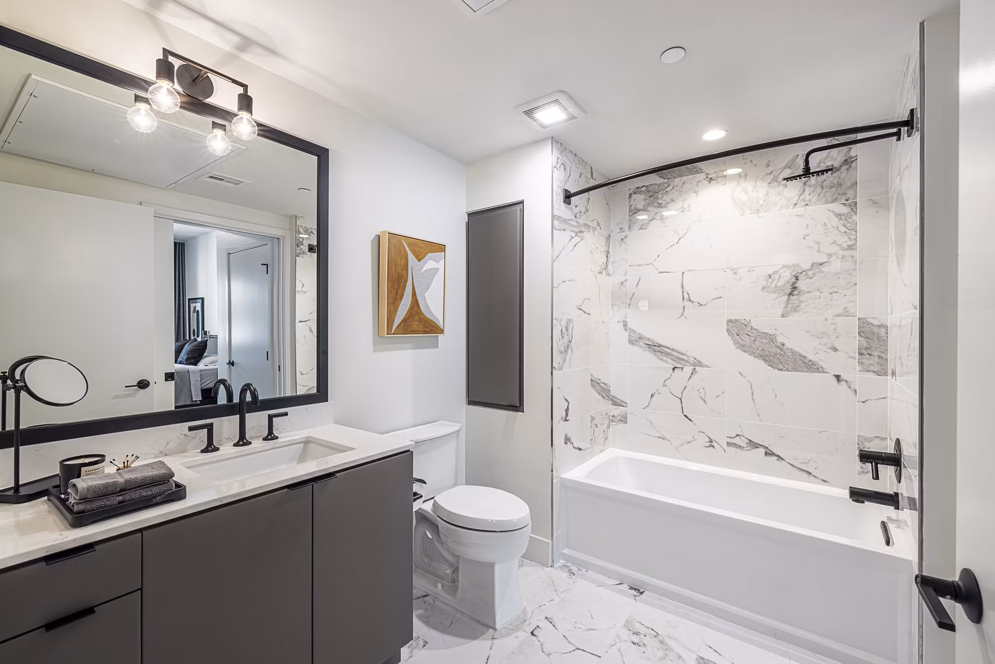 Bathroom with elegant marble countertops and modern fixtures in Hollywood Park Apartments