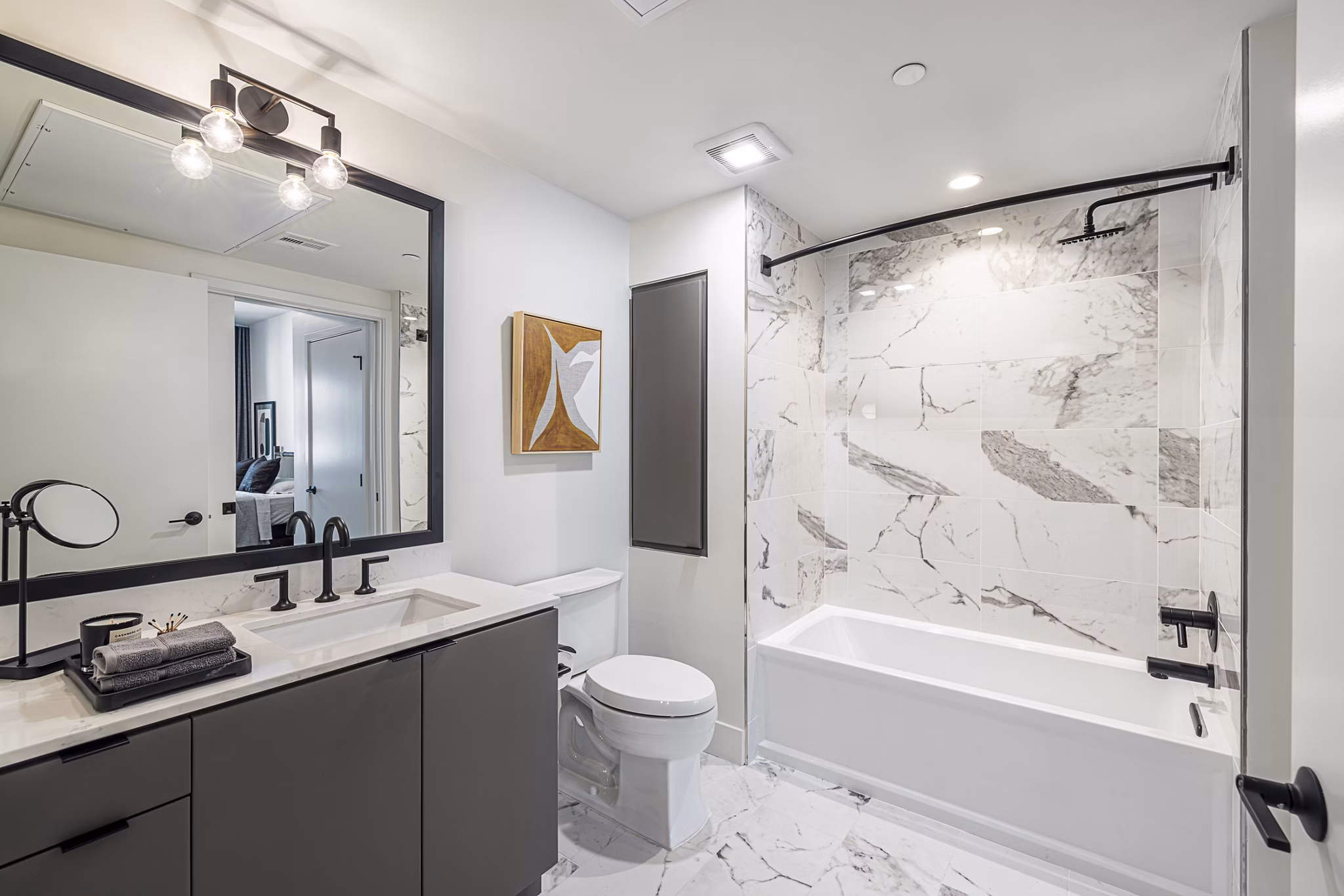 Bathroom with elegant marble countertops and modern fixtures in Hollywood Park Apartments