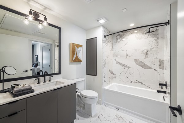 Bathroom with elegant marble countertops and modern fixtures in Hollywood Park Apartments