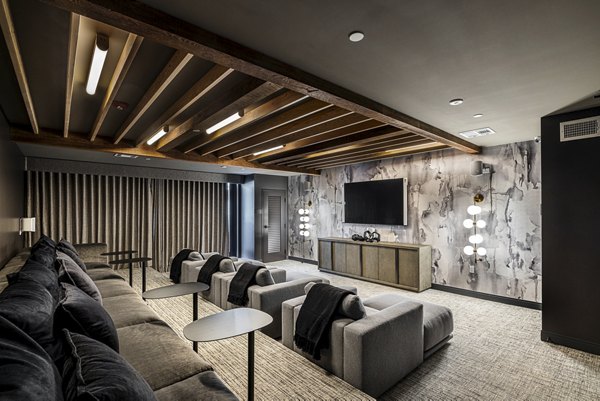 Theater room with plush seating and large screen at Hollywood Park Apartments