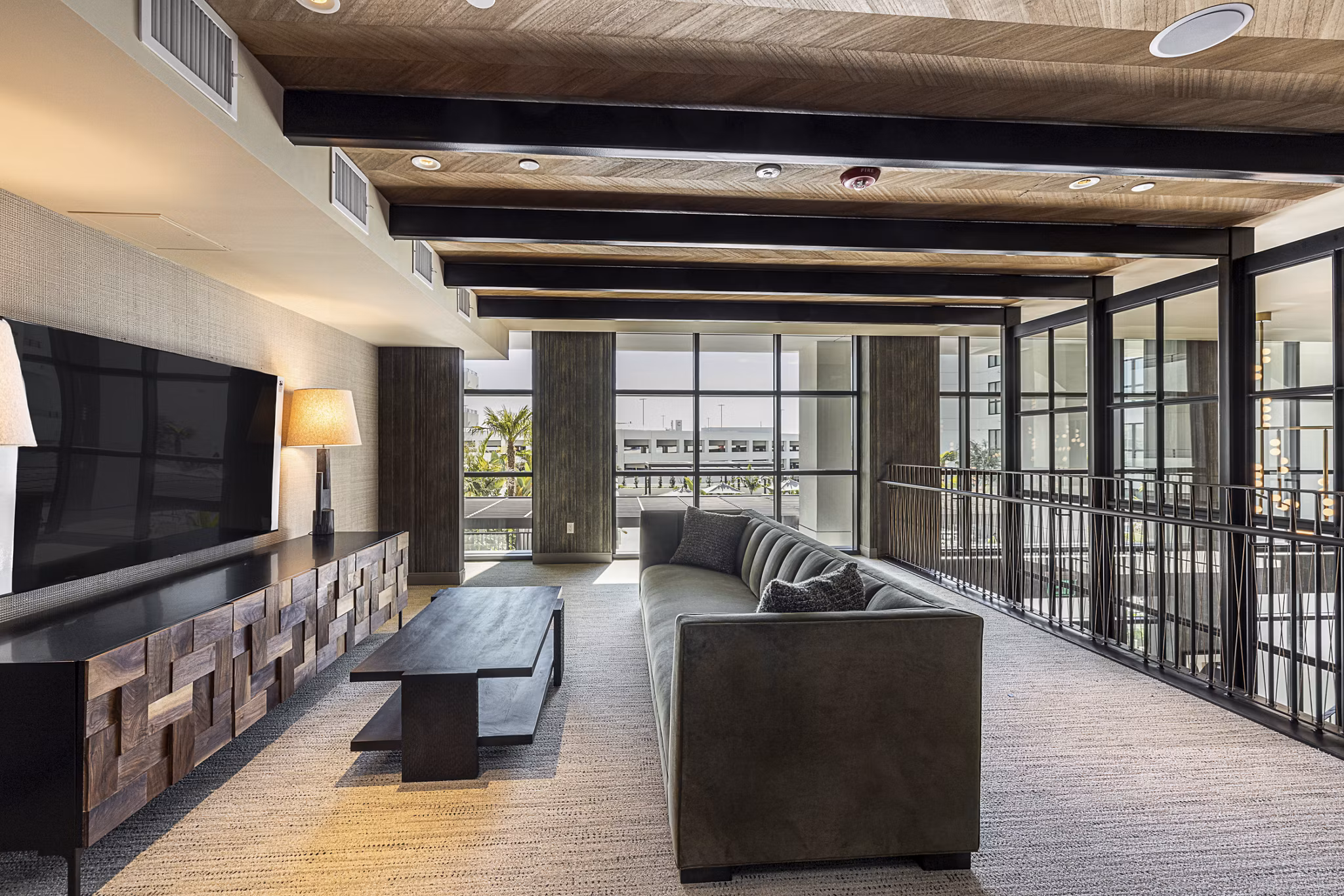 Modern clubhouse with stylish decor at Hollywood Park Apartments, featuring cozy seating and vibrant lighting